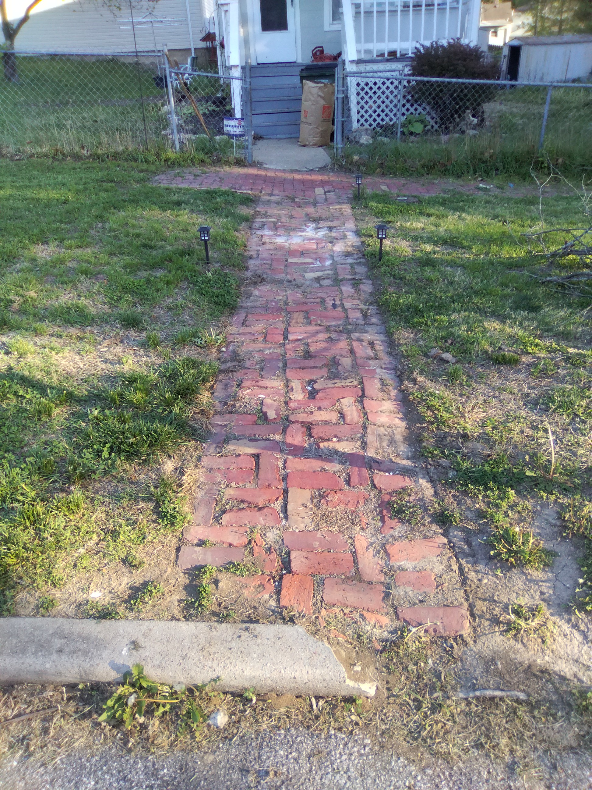 Brick sidewalks now trimmed and edged clean